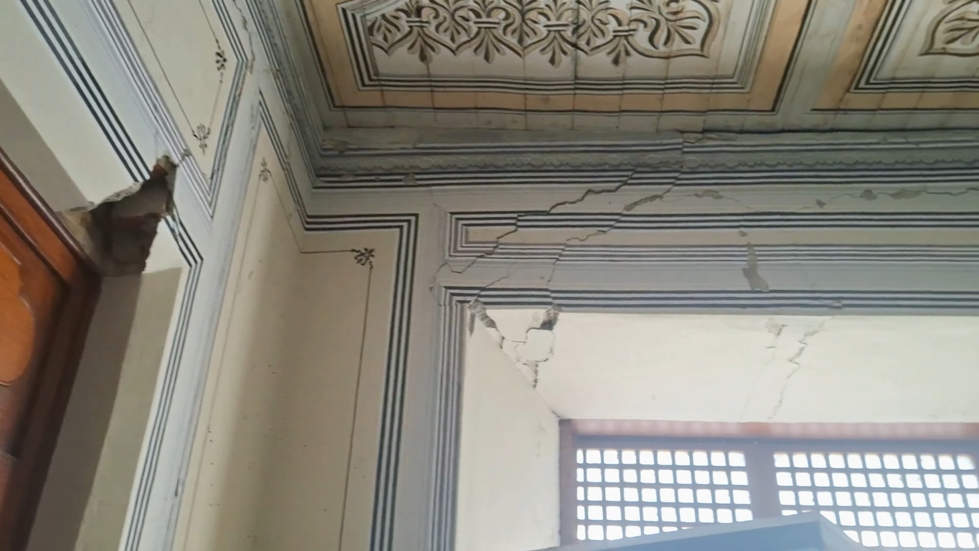 Close-up of the damaged stone walls and sliding capiz windows of the Bahay na Bato