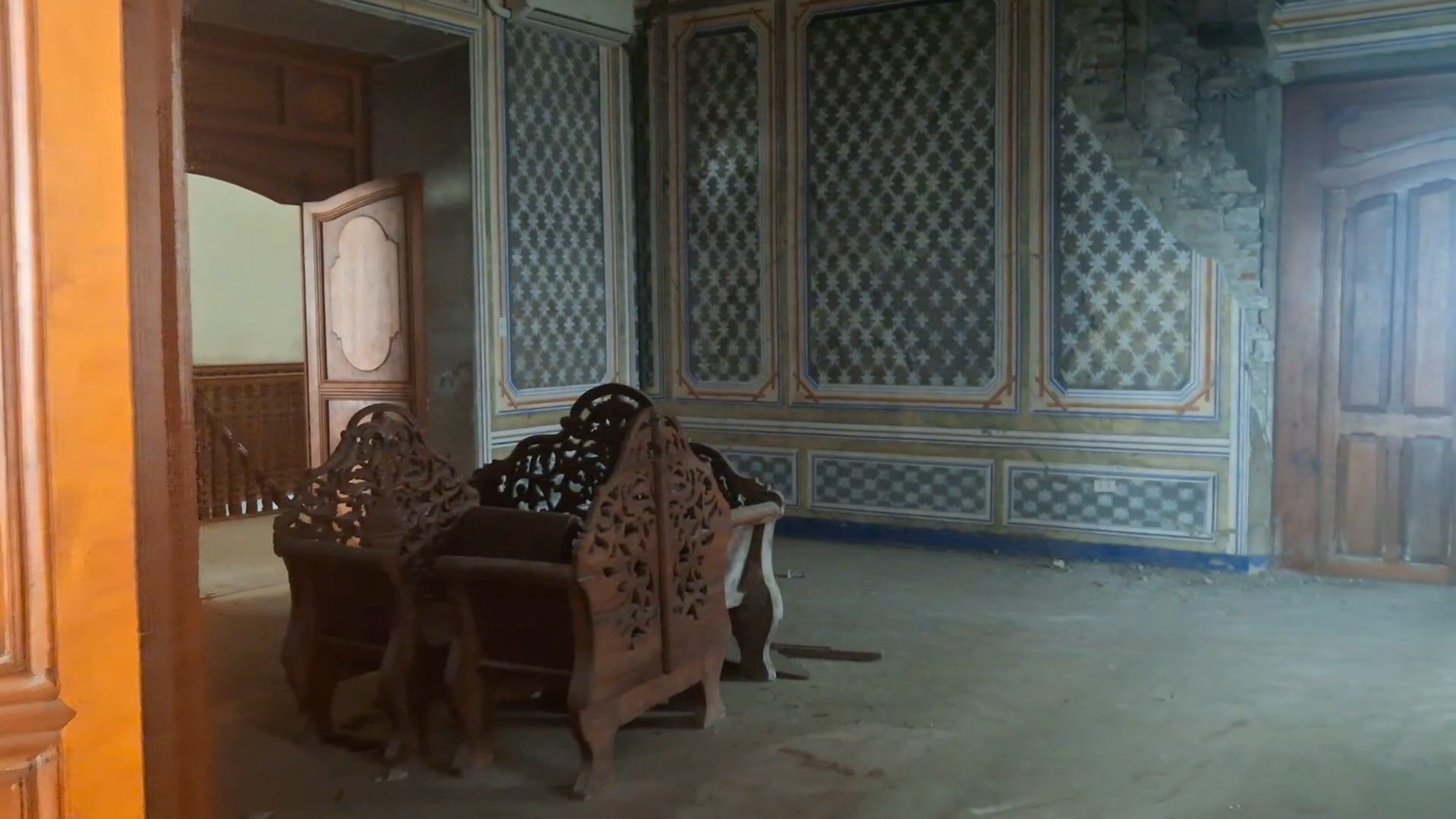 Weathered wooden floors and antique furniture inside the Cariño House museum