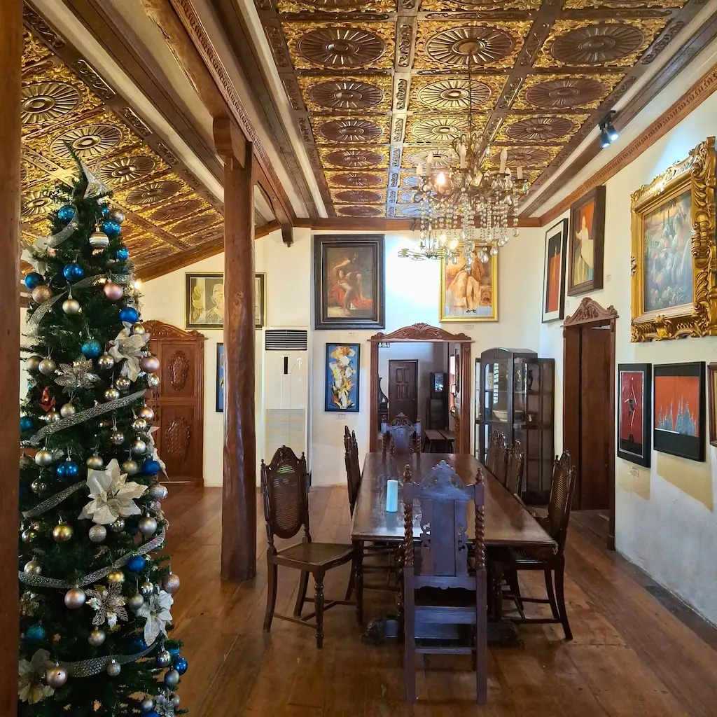 Modern art paintings hung on the antique wooden walls of the Dario Museum