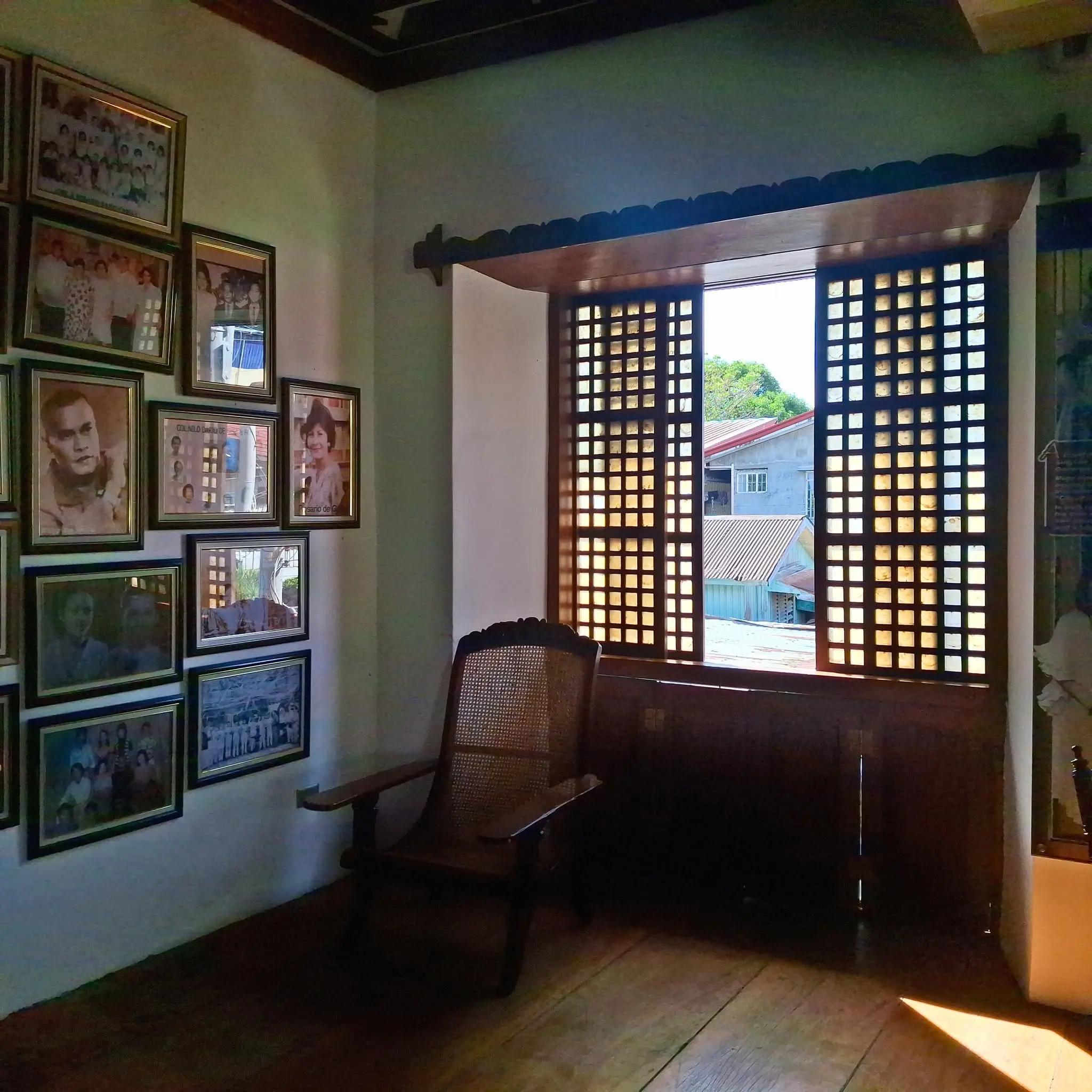 Interior view of the Dario Ancestral House highlighting the wooden floors and sliding capiz shell windows