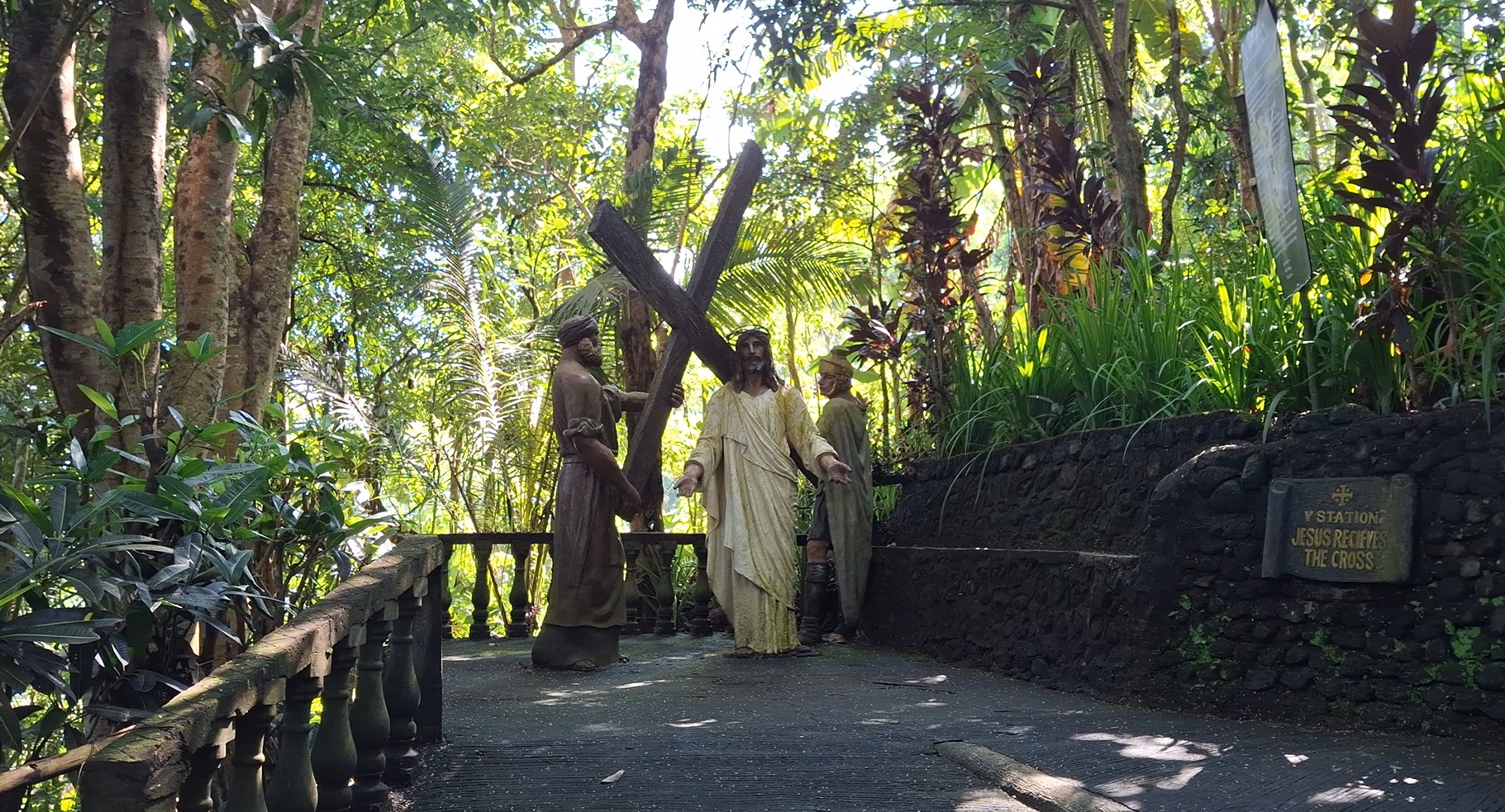 Life-sized statues depicting the Stations of the Cross along the tropical trail