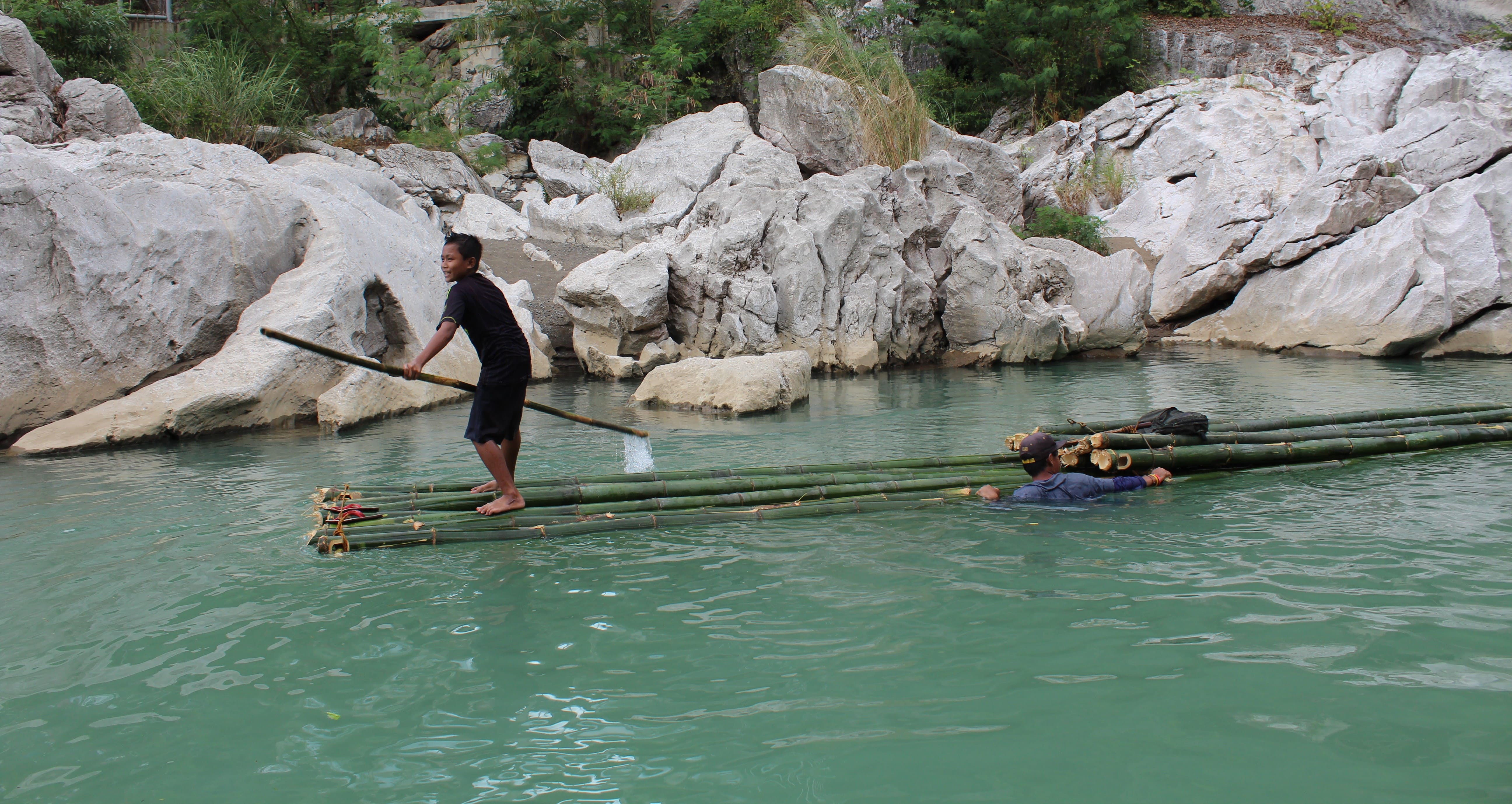 Local children practicing bamboo rafting in Minalungao National Park