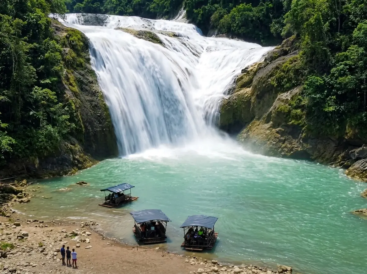 Visitors enjoying bamboo rafts in the wide catch basin of Pinsal Falls