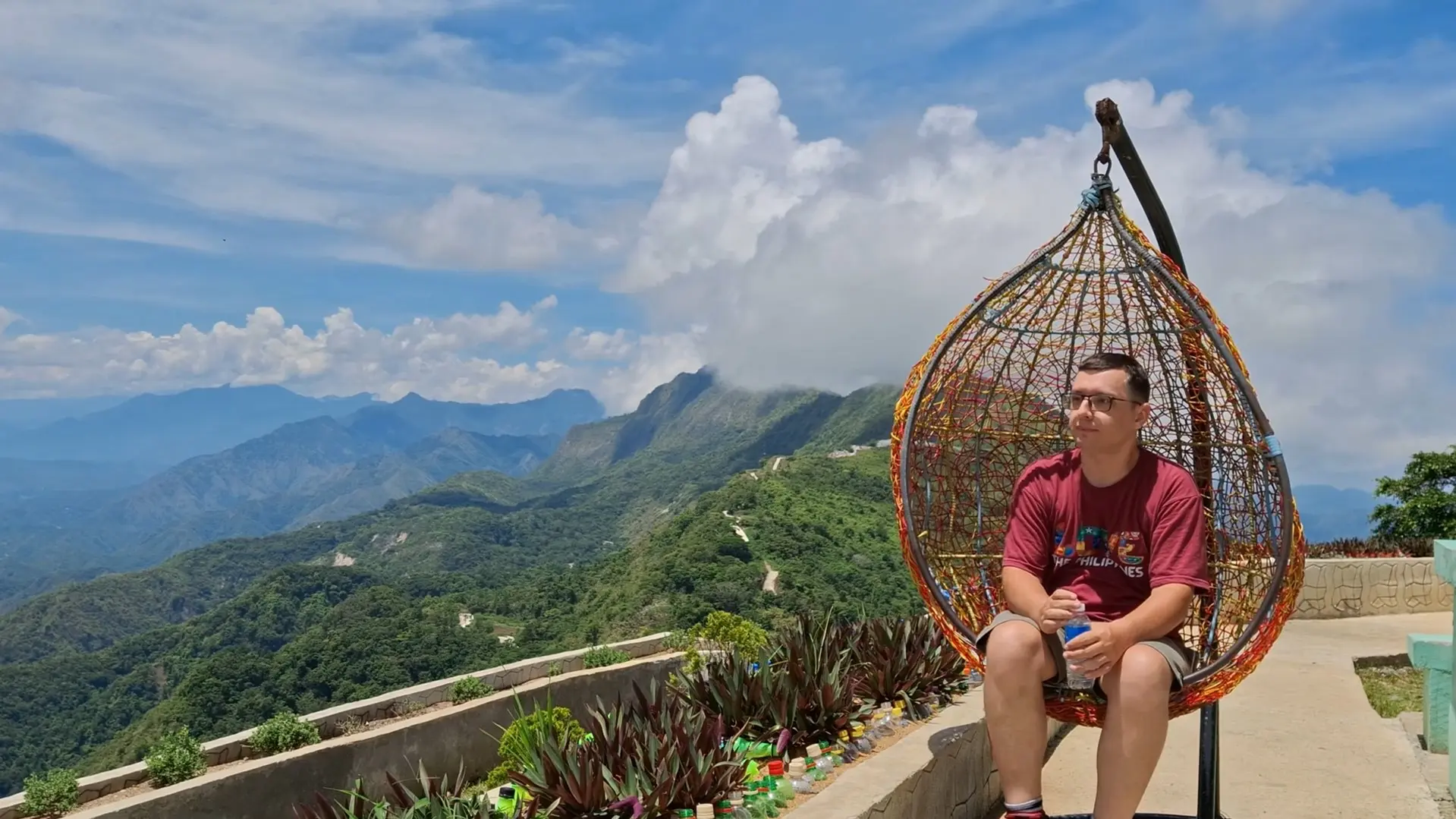 A traveler enjoying the cool morning breeze and expansive mountain views in Cayus, Quirino